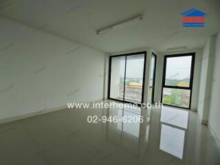 Empty room with large windows and reflective floor