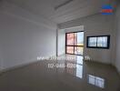 Empty room with tiled flooring and large windows