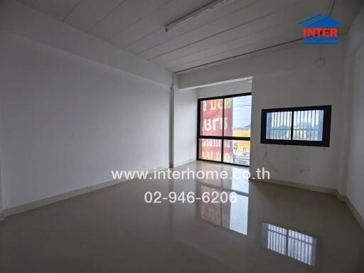 Empty room with tiled flooring and large windows