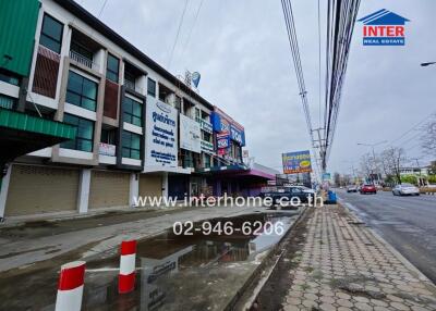Street view of commercial buildings with store signs