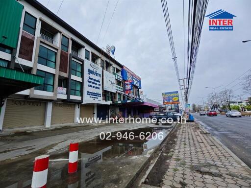 Street view of commercial buildings with store signs