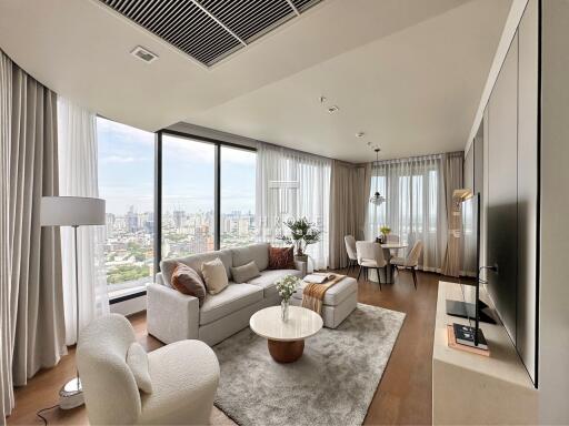 Spacious and modern living room with large windows and city view