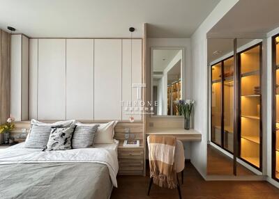 Cozy and modern bedroom with wooden accents, double bed, vanity desk, and walk-in closet