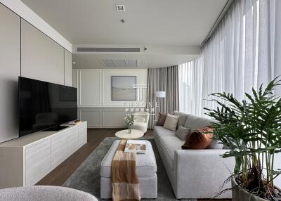 Modern living room with large TV, couch, and coffee table