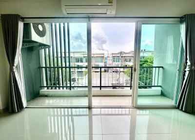 spacious living room with large windows and air conditioning