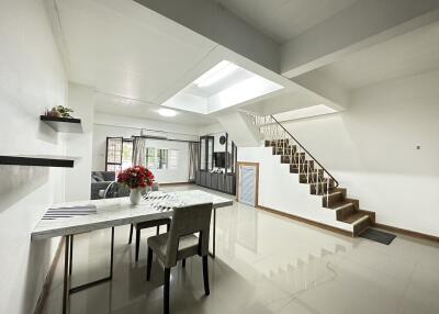 Main living space with dining area, skylight, staircase, and open layout
