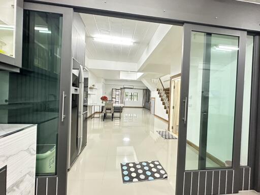 Spacious view of the main living area with modern kitchen and staircase