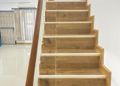 Wooden staircase leading to the upper floor with polished handrail