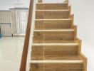 Wooden staircase leading to the upper floor with polished handrail