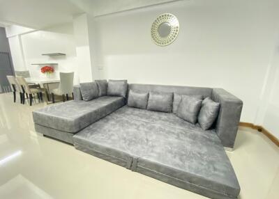Living room with a large gray sectional sofa and modern decor