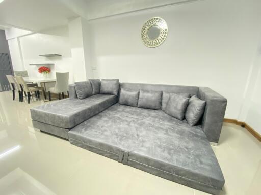 Living room with a large gray sectional sofa and modern decor