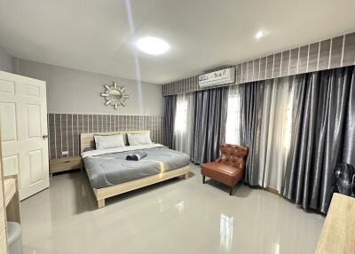 Spacious and modern bedroom with a comfortable bed and stylish decor