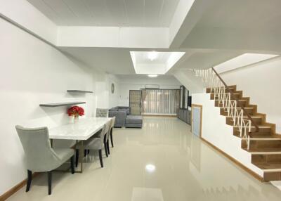 Modern living room with dining area and staircase
