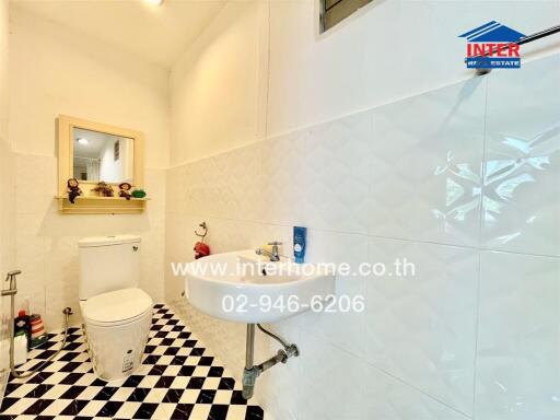bathroom with checkered floor and white fixtures