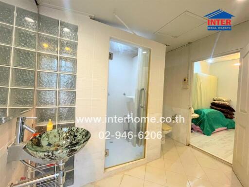 Bathroom with glass sink and shower area