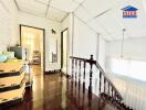 upstairs hallway with wooden floors and railing