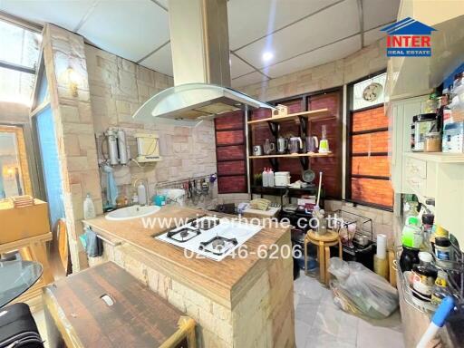 Modern kitchen with built-in appliances and stone wall finishes