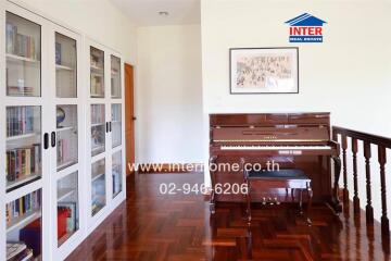 Hallway with a piano and bookshelf