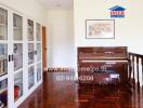 Hallway with a piano and bookshelf