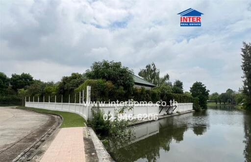 scenic view of a property with surrounding greenery and a waterway