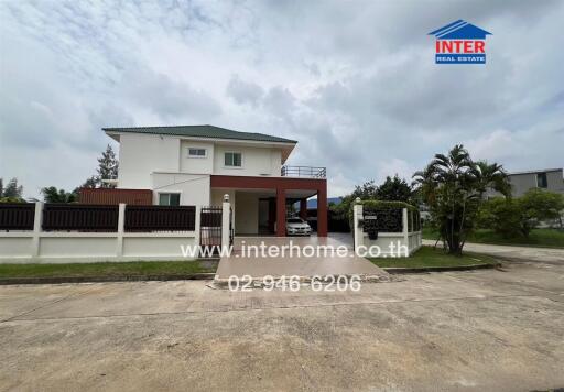 Two-story house exterior with driveway and garage