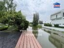 View of modern property with canal and lush greenery