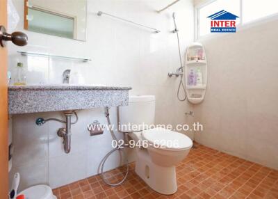 Bathroom with a large mirror, sink, toilet, and shower area