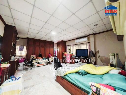 Spacious living area with furniture and household items