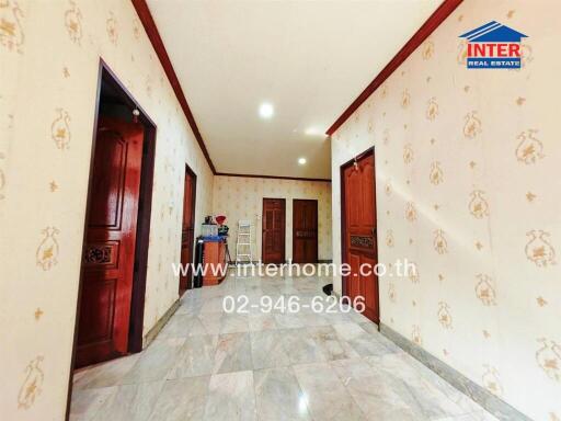 Spacious and well-lit hallway with decorative walls and multiple doorways