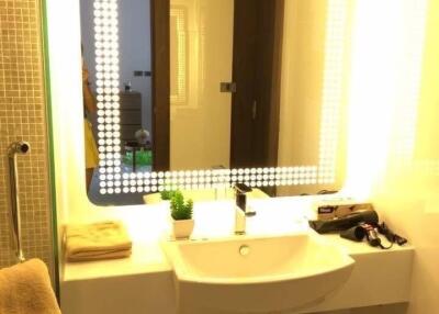 Modern bathroom with illuminated mirror and sink