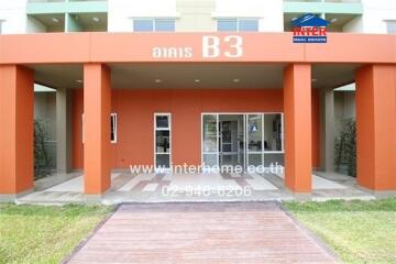 Front entrance of a building with red pillars and glass doors