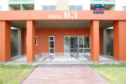 Front entrance of a building with red pillars and glass doors