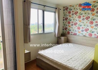 Bedroom with large window and floral wallpaper