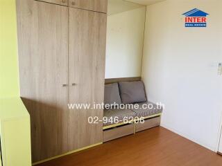 Bedroom with wooden wardrobe and sofa