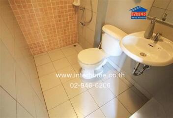 Small bathroom with tiled walls and modern fixtures