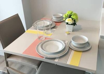 A neatly set dining table with chairs