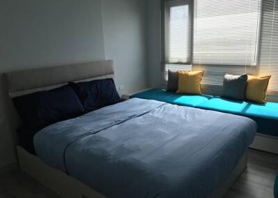 Bedroom with a bed and seating area next to the window