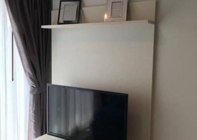 Modern living room with wall-mounted TV and shelving