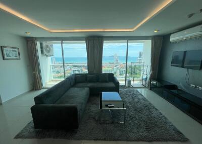 Living room with a large window offering a sea view