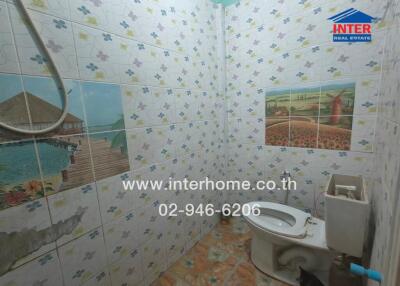 Bathroom with decorative tiles and toilet