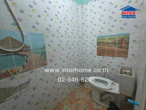 Bathroom with decorative tiles and toilet