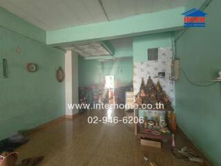 Main living area with wooden flooring and various items