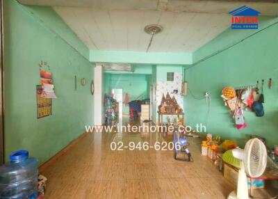 Open living area with wooden flooring and bright green walls