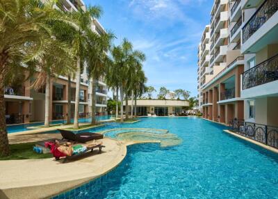 Pool area with adjacent buildings and palm trees