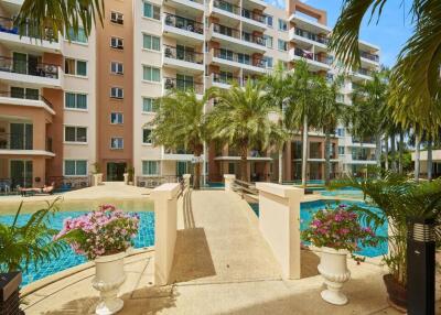 Condominium complex with swimming pool and lush landscaping