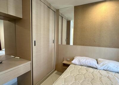 Spacious bedroom with built-in wardrobe and bed
