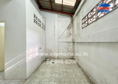 Utility area with tiled floor and ventilation