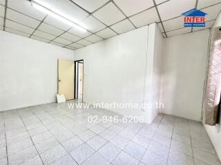 Unfurnished room with tiled floors and window with curtain