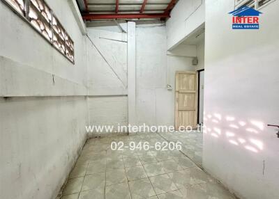 Empty room with tiled floor and concrete walls