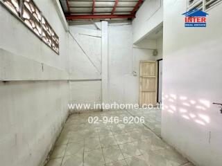 Empty room with tiled floor and concrete walls